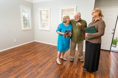 Female Real Estate Agent Handing New House Keys to Senior Adult royalty free stock image Female Real Estate Agent Handing New House Keys to Senior Adult royalty free stock image