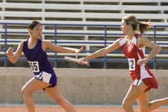 Female Runners In Relay Race