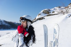 Female Skier Warming Hands on Sunny Mountainside Stock Photo Female Skier Warming Hands on Sunny Mountainside Stock Photo