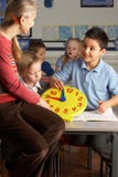Female Teacher In Primary School Teaching Children stock photo Female Teacher In Primary School Teaching Children stock photo