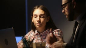 Female trainee listening to mentor teaching young woman in office
