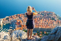 Female Traveller Make A Photo Of Dubrovnik To The Phone. Royalty Free Stock Photography