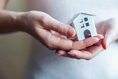 Female woman hands holding miniature white toy house royalty free stock image Female woman hands holding miniature white toy house royalty free stock image