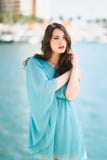 Femme avec des yeux bleus portant la robe bleue dans la plage Photographie stock libre de droits Femme avec des yeux bleus portant la robe bleue dans la plage Photographie stock libre de droits
