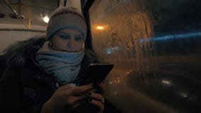 Femme employant la cellule tout en voyageant en autobus dans la ville de nuit banque de vidéos Femme employant la cellule tout en voyageant en autobus dans la ville de nuit banque de vidéos