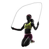 Femme exerçant la silhouette de corde à sauter de forme physique Photos libres de droits Femme exerçant la silhouette de corde à sauter de forme physique Photos libres de droits