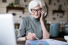 Femme supérieure occupée à l'aide du téléphone photographie stock libre de droits Femme supérieure occupée à l'aide du téléphone photographie stock libre de droits