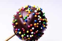 Feriemat f?r ungar Kake-pop - efterr?tt p? en pinne Ljus efterr?tt som t?ckas med choklad och f?rgrika bollar royaltyfria foton Feriemat f?r ungar Kake-pop - efterr?tt p? en pinne Ljus efterr?tt som t?ckas med choklad och f?rgrika bollar royaltyfria foton