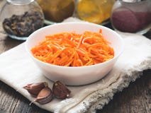 Fermented vegetables, Korean carrots. Asian spicy salad in white plate on wooden background stock photography Fermented vegetables, Korean carrots. Asian spicy salad in white plate on wooden background stock photography