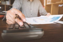 Fermez-vous de la main utilisant la calculatrice, homme d'affaires travaillant au bureau o image stock Fermez-vous de la main utilisant la calculatrice, homme d'affaires travaillant au bureau o image stock