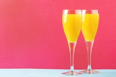 Festive Alcohol Cocktail Mimosa With Orange Juice And Cold Dry Champagne Or Sparkling Wine In Glasses, Pink Treandy Background, Royalty Free Stock Image