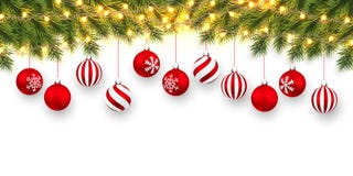 Festive Christmas or New Year Background. Christmas fir-tree branches with light garland and xmas red balls. Holiday`s Background