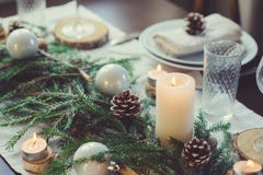 Festive Christmas and New Year table setting in scandinavian style with rustic handmade details in natural and white tones Stock Images Festive Christmas and New Year table setting in scandinavian style with rustic handmade details in natural and white tones Stock Images