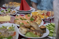 A festive table in the center of which stands a plate of sandwiches with red fish stock photos A festive table in the center of which stands a plate of sandwiches with red fish stock photos