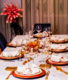 Festive table decorated with gold colored plates and cutlery stock photo Festive table decorated with gold colored plates and cutlery stock photo