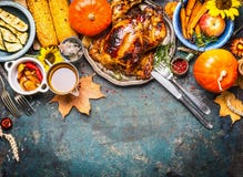 Festive Thanksgiving Day food background with roasted whole turkey or chicken and sauce, harvest vegetables royalty free stock photo Festive Thanksgiving Day food background with roasted whole turkey or chicken and sauce, harvest vegetables royalty free stock photo