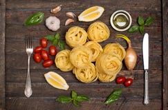 Fettuccine with ingredients for cooking pasta on wooden backgrou Stock Photo Fettuccine with ingredients for cooking pasta on wooden backgrou Stock Photo