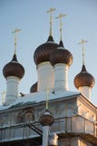 Few domes with crosses over a white-stone temple against a blue sky royalty free stock image Few domes with crosses over a white-stone temple against a blue sky royalty free stock image
