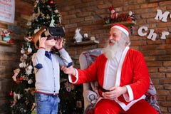 Small energetic boy plays interesting game in glasses of virtual Stock Image Small energetic boy plays interesting game in glasses of virtual Stock Image