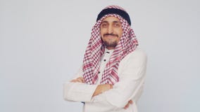 The field of business and trade. A man with a beard and national dress smiling. Arab in a modern office folded his hands stock video The field of business and trade. A man with a beard and national dress smiling. Arab in a modern office folded his hands stock video
