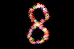 Figure 8 multi-colored bokeh on a black background.On March 8 stock image Figure 8 multi-colored bokeh on a black background.On March 8 stock image