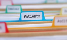 File folders with a tab labeled Patients stock photos File folders with a tab labeled Patients stock photos