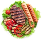Filete, salchichas y verduras asados a la parrilla. imagen de archivo libre de regalías Filete, salchichas y verduras asados a la parrilla. imagen de archivo libre de regalías