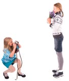 Filles de l'adolescence avec le rétro appareil-photo sur un fond blanc photos stock Filles de l'adolescence avec le rétro appareil-photo sur un fond blanc photos stock