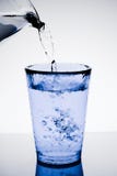 Filling a blue glass with pure water and bubbles royalty free stock photos Filling a blue glass with pure water and bubbles royalty free stock photos