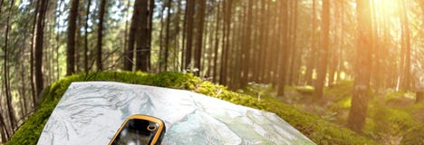 Finding the right position in the forest via gps stock image Finding the right position in the forest via gps stock image