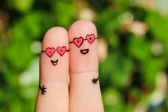 Finger art of a Happy couple. A man and a woman hug in pink glasses in shape of hearts. stock image Finger art of a Happy couple. A man and a woman hug in pink glasses in shape of hearts. stock image