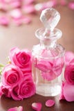 Fiori della bottiglia di profumo e della rosa di rosa Stazione termale aromatherapy fotografia stock libera da diritti Fiori della bottiglia di profumo e della rosa di rosa Stazione termale aromatherapy fotografia stock libera da diritti