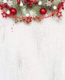 Fir branch with Christmas decorations on old wooden shabby background with empty space for text. Top view
