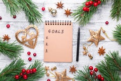Fir branches, gifts and an notebook on a light wooden background. New goals. Cranberries, spices, holly berries royalty free stock images Fir branches, gifts and an notebook on a light wooden background. New goals. Cranberries, spices, holly berries royalty free stock images