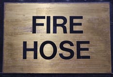 Fire Hose Sign on Gold Brass Background royalty free stock images Fire Hose Sign on Gold Brass Background royalty free stock images