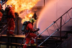 Firefighter Team Using Water Fog Spraying Down Fire From Oil Rig Factory Explosion Royalty Free Stock Image Firefighter Team Using Water Fog Spraying Down Fire From Oil Rig Factory Explosion Royalty Free Stock Image