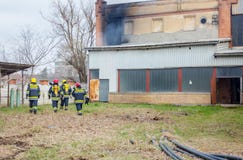 Firefighters are oversees burning industrial building, ready for stock photography Firefighters are oversees burning industrial building, ready for stock photography
