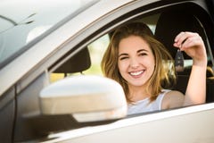 First car - young woman with keys royalty free stock images First car - young woman with keys royalty free stock images