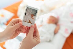 The first photo of a newborn in the hands of a female mother against a child stock photography The first photo of a newborn in the hands of a female mother against a child stock photography