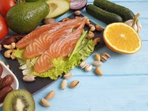 Fish salmon omega 3 avocado on blue wooden background healthy food stock photography Fish salmon omega 3 avocado on blue wooden background healthy food stock photography