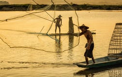 Fisherman in action when fishing in the lake stock image Fisherman in action when fishing in the lake stock image