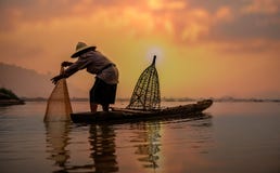 Fisherman of Lake in action when fishing stock photography Fisherman of Lake in action when fishing stock photography