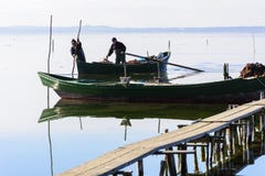 Fishermen With Their Ancient Boats, Fall At Dawn. Sardinia South West Stock Photo Fishermen With Their Ancient Boats, Fall At Dawn. Sardinia South West Stock Photo
