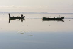 Fishermen With Their Ancient Boats, Fall At Dawn. Sardinia South West Royalty Free Stock Images