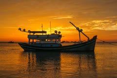 Fishing boat on the background of a sunset