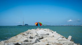 Fishing rods and colourful umbrella on rock coast Royalty Free Stock Photos Fishing rods and colourful umbrella on rock coast Royalty Free Stock Photos