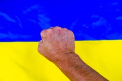 Fist on the background of the Ukrainian flag - Independence Day stock photo Fist on the background of the Ukrainian flag - Independence Day stock photo