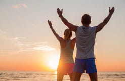 Fit couple with their hands up Stock Images Fit couple with their hands up Stock Images