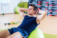 Fit man doing sit-ups on exercise balls. royalty free stock photo Fit man doing sit-ups on exercise balls. royalty free stock photo