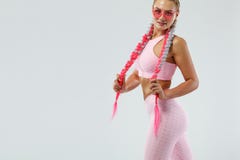 Fitenss athlete woman in a beautiful pink sportswear and pink glasses, on white background. Sport concept. royalty free stock photo Fitenss athlete woman in a beautiful pink sportswear and pink glasses, on white background. Sport concept. royalty free stock photo